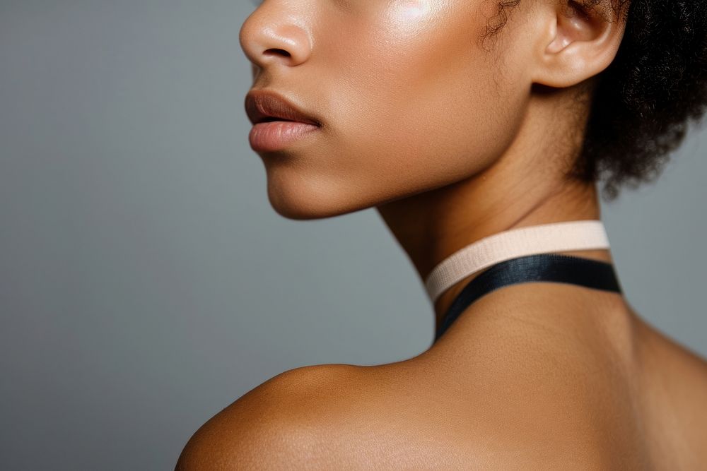 Medical band on black woman shoulder adult skin perfection.