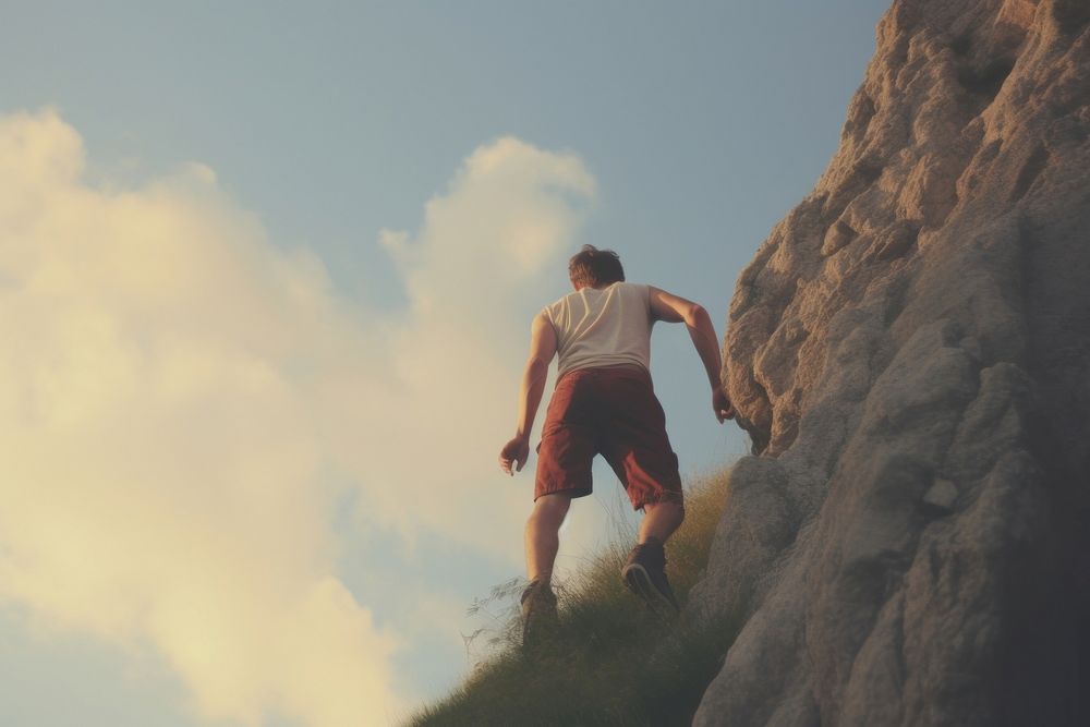 Person climbs up adventure mountain outdoors. AI generated Image by rawpixel.