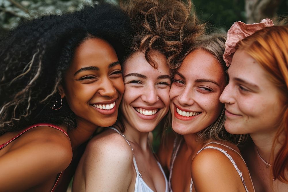 Group of happy women embracing laughing smiling.