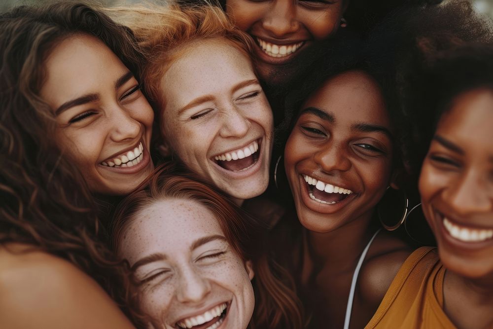 Group of happy women embracing laughing smiling.
