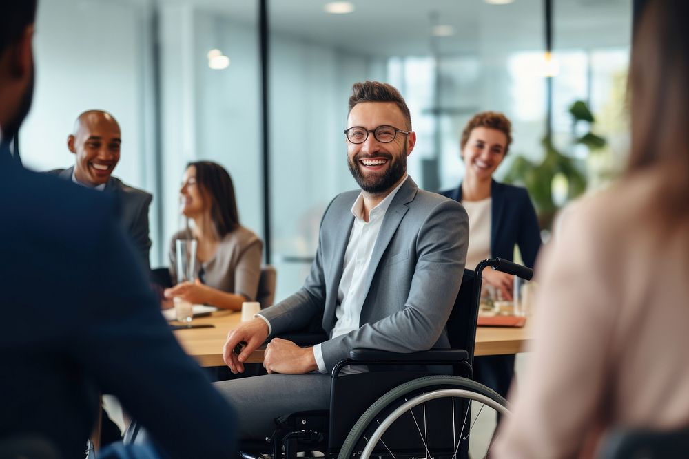 Man in a wheelchair in a business meeting smiling adult togetherness.