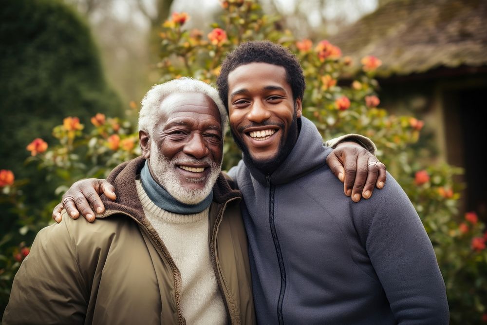 Young man and old black man hugging each other portrait smiling adult.