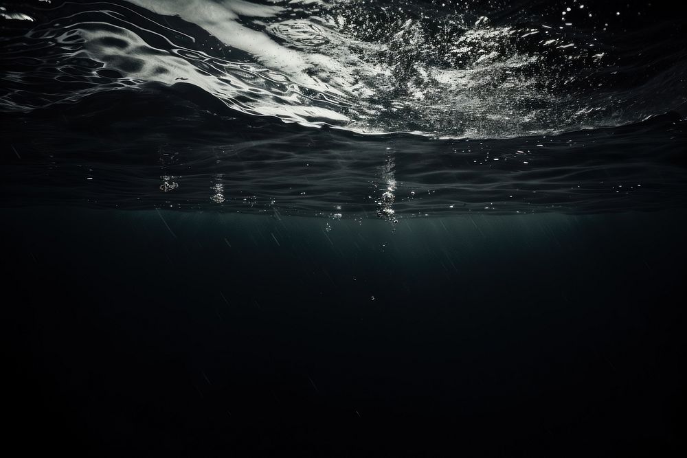 Dark background underwater monochrome swimming.