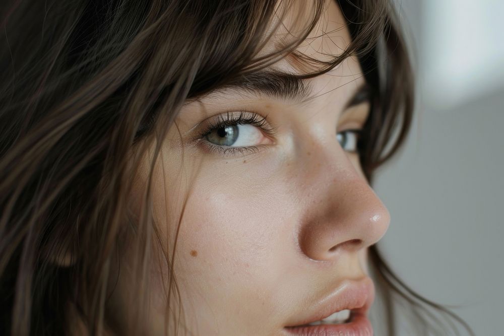 Close-up photo of a woman skin contemplation hairstyle.