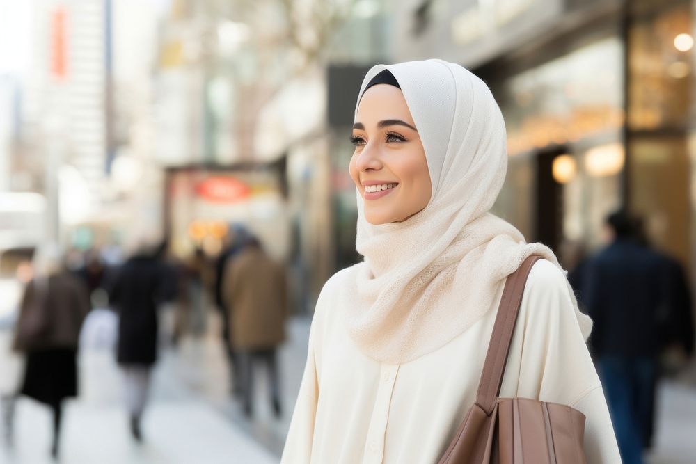 A happy Middle east woman with shopping bags looking street scarf.