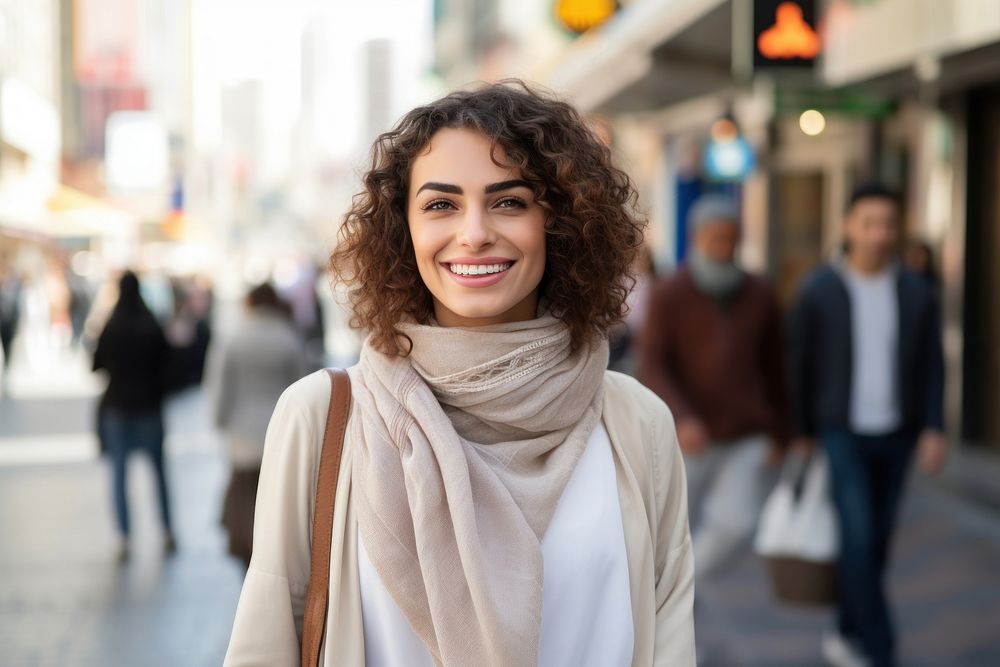 A happy Middle east woman in casual attire walk along a crosswalk street scarf adult.