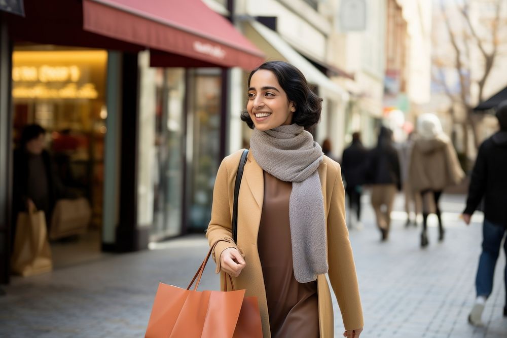 A joyful Middle east woman with shopping bags street scarf adult.