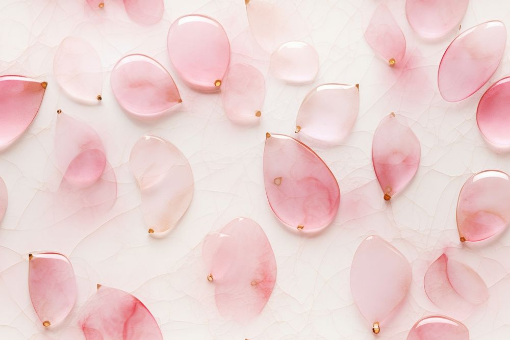 Translucent water drops shaped in shades of dusty rose tile of pink marble backgrounds jewelry.