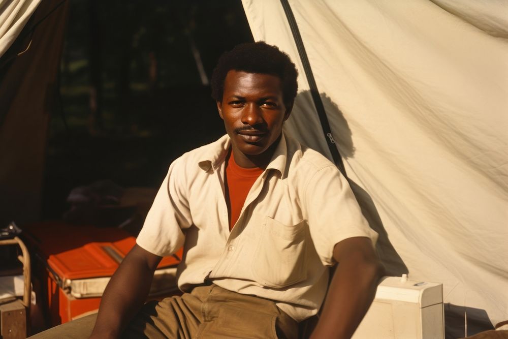 African man travelling portrait outdoors sitting.