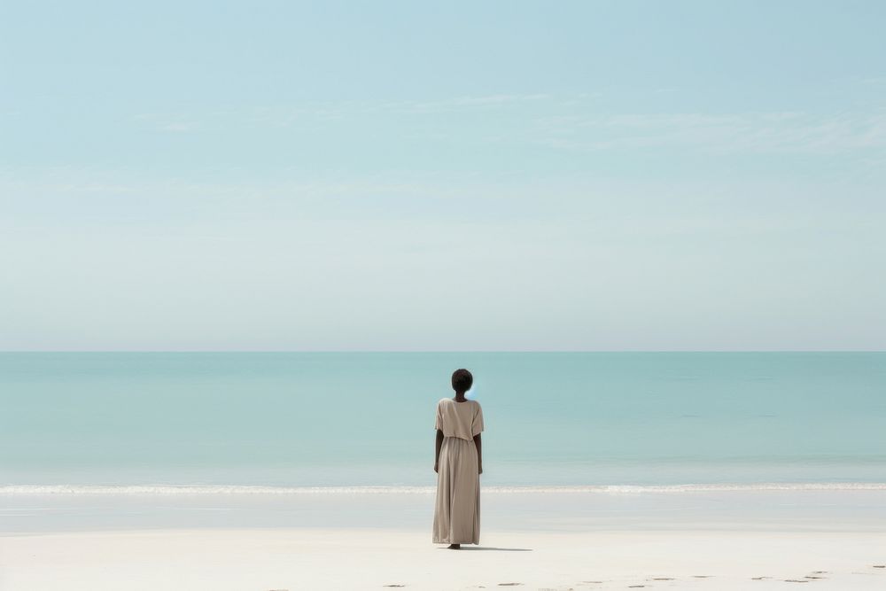 African girl on beach standing outdoors horizon.