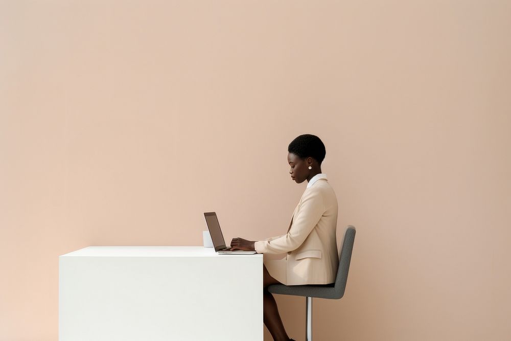 African woman in office furniture computer sitting.