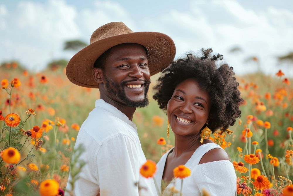 African couple flower field portrait.
