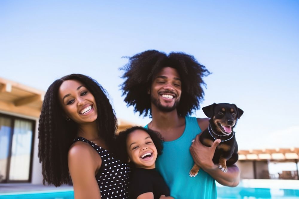 Black family and someone holding puppy laughing swimming mammal.