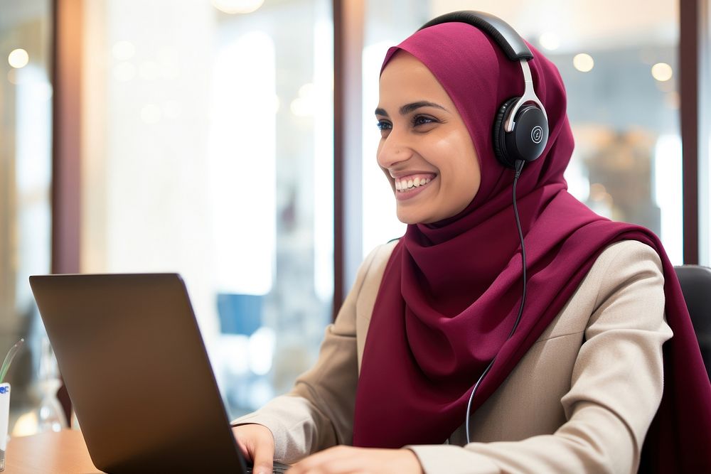 Qatari woman working at call center laptop computer scarf.