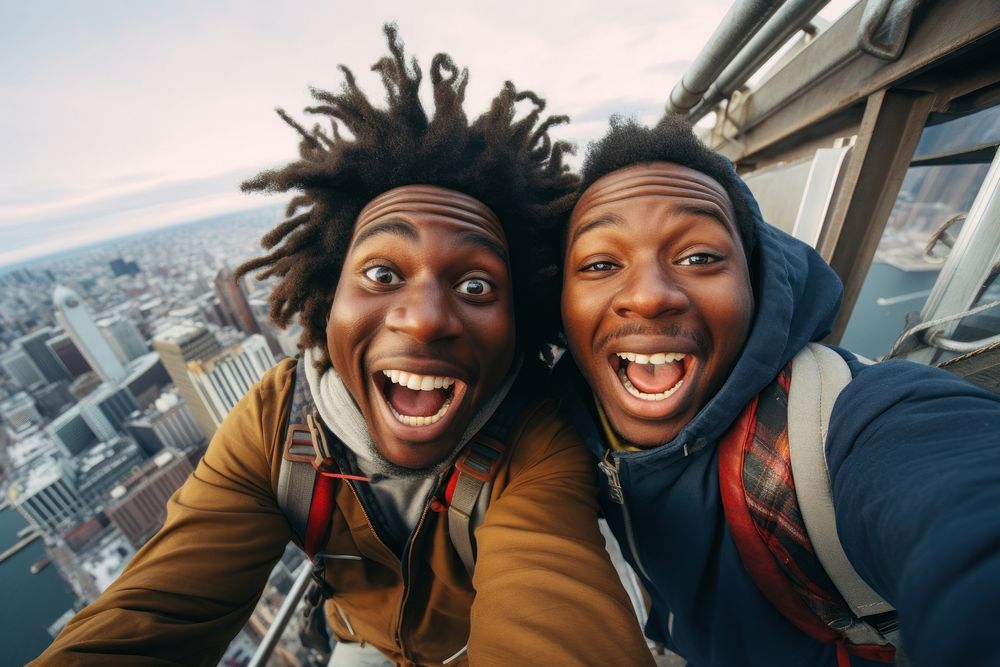 African American travelers taking a selfie together city laughing portrait.