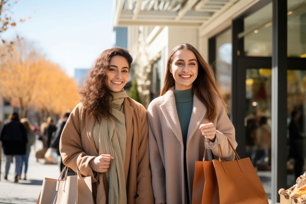 Young adult Iranian women shopping together handbag happy coat.