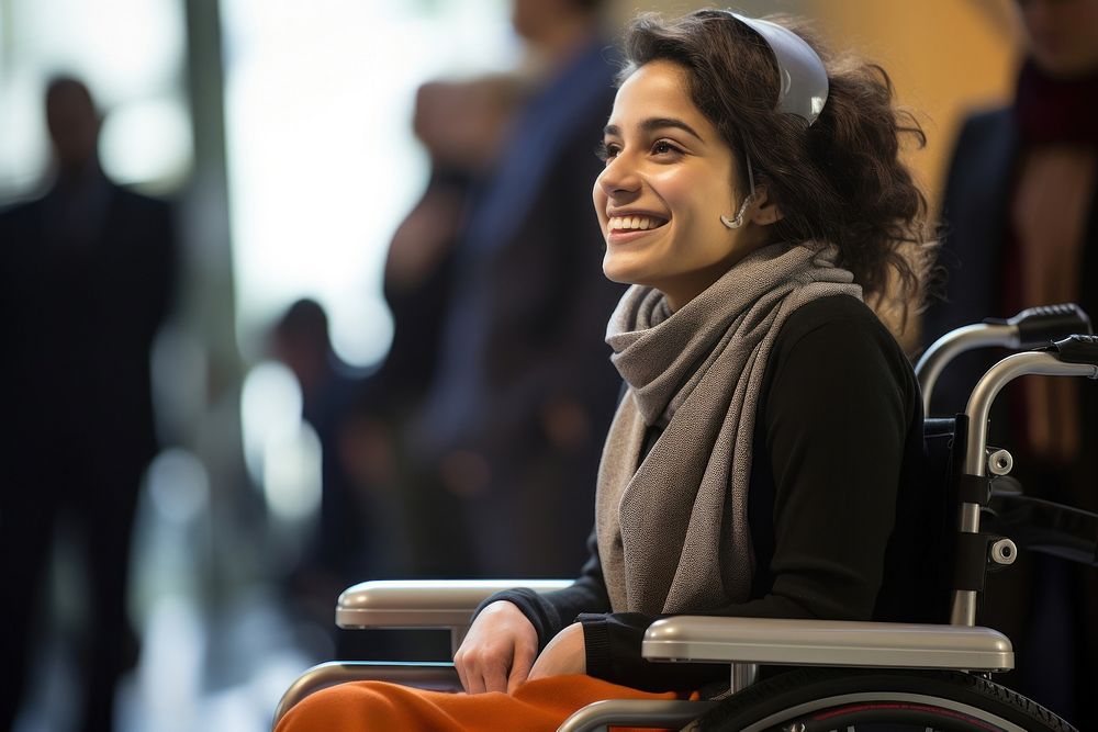 Young generation Iranian woman speaker on wheelchair on stage in casual meeting smiling adult smile.