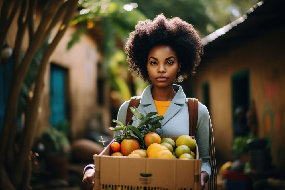 Girl with cardboard box carrying fruit and vegetables adult green afro.