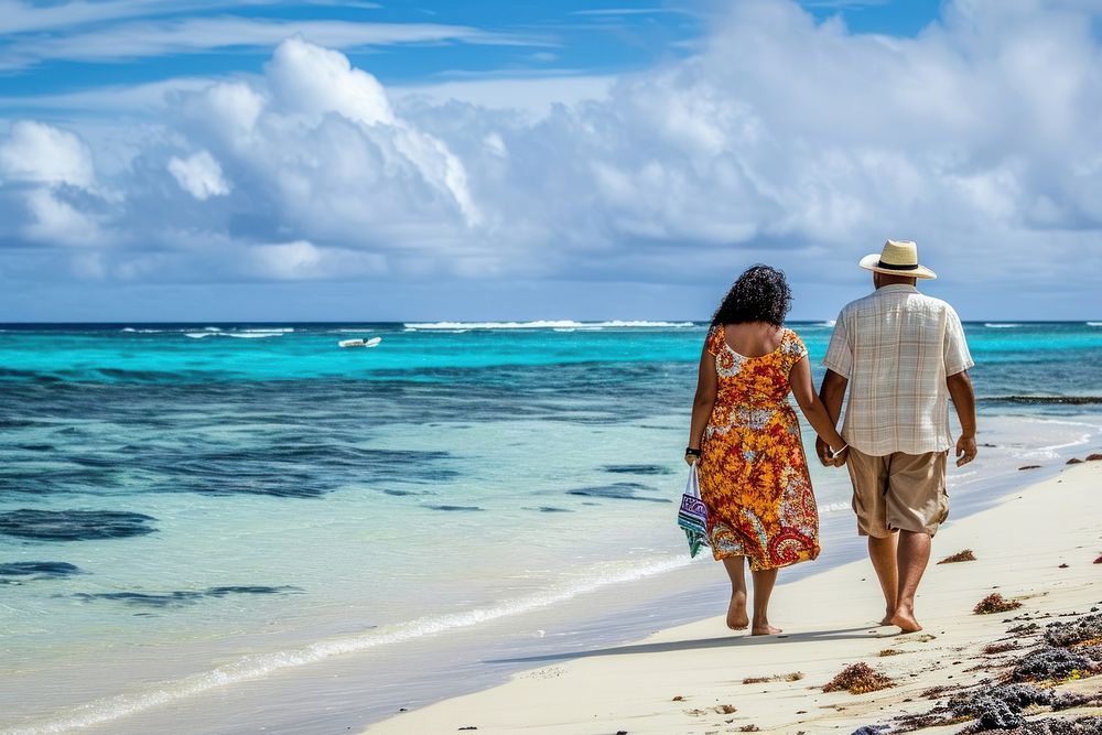 Pacific islander couple vacation walking beach.