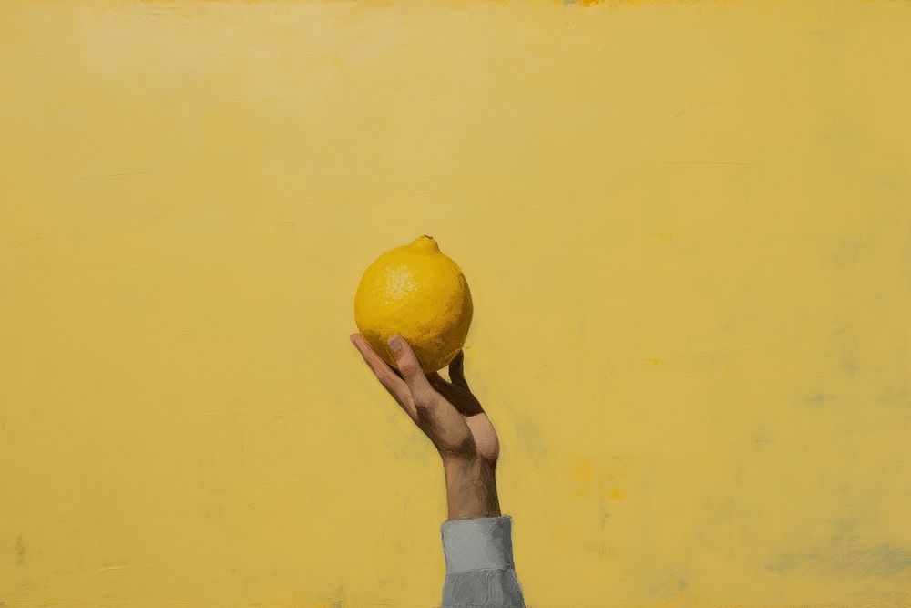 Hand holding lemon painting fruit plant.