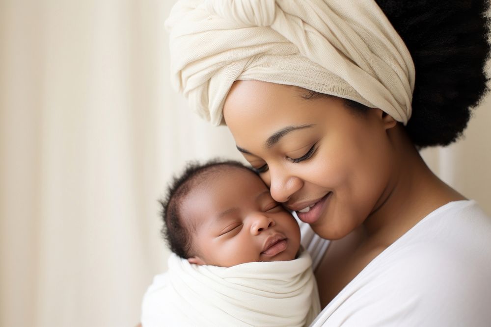 Woman kiss on her newborn baby boy head portrait smiling photo. 