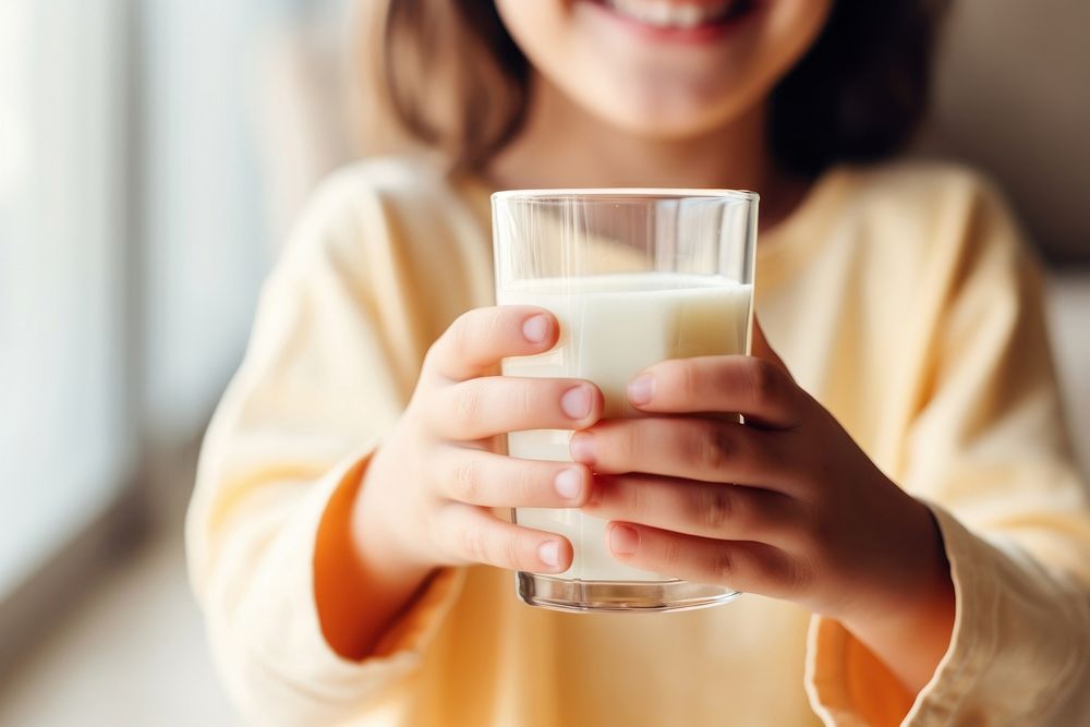 Kid hands in holding milk e in glass smiling drink dairy. AI generated Image by rawpixel.