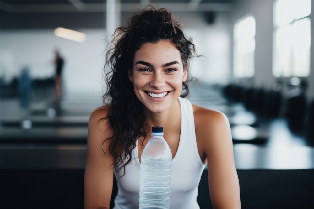 Woman hands in sport wear holding sport water drink smiling sports smile. 