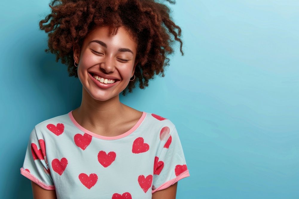 Woman wearing heart-shaped matching shirts laughing smiling smile.