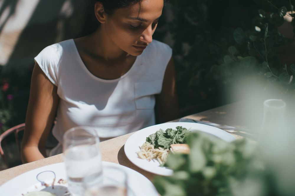 A woman dining in the garden plate food refreshment. AI generated Image by rawpixel.