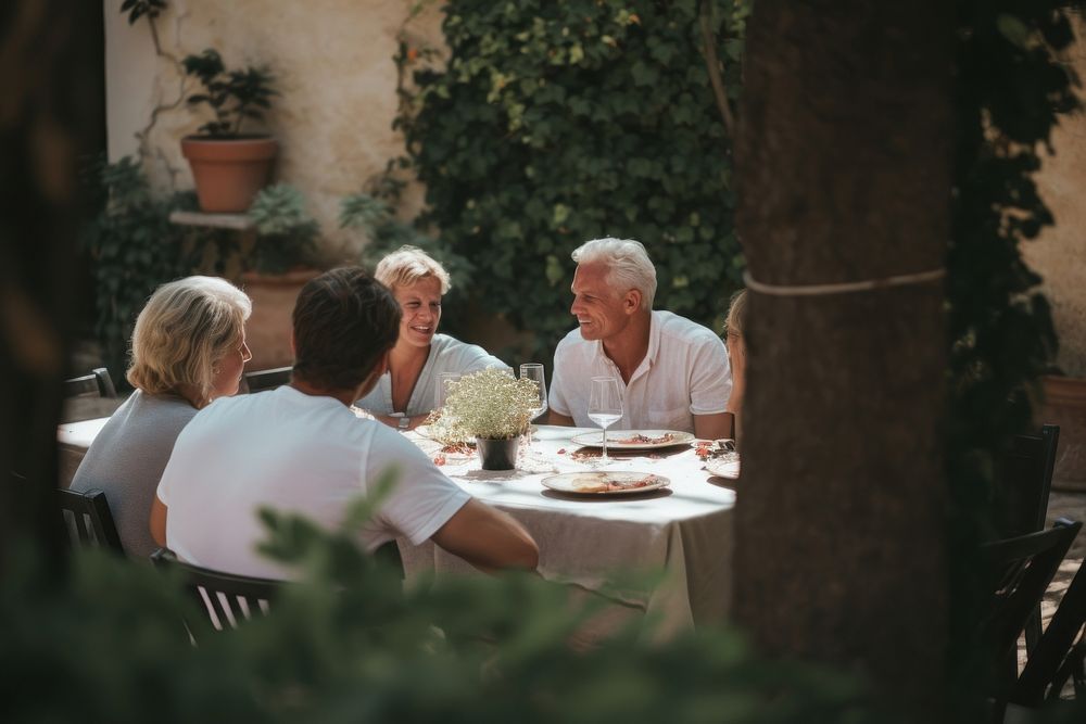 Friends dining in the garden adult table plant. AI generated Image by rawpixel.