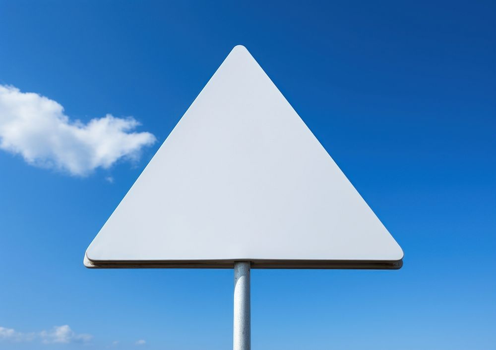 Blank white traingle traffic sign attached metal pole sky outdoors symbol.