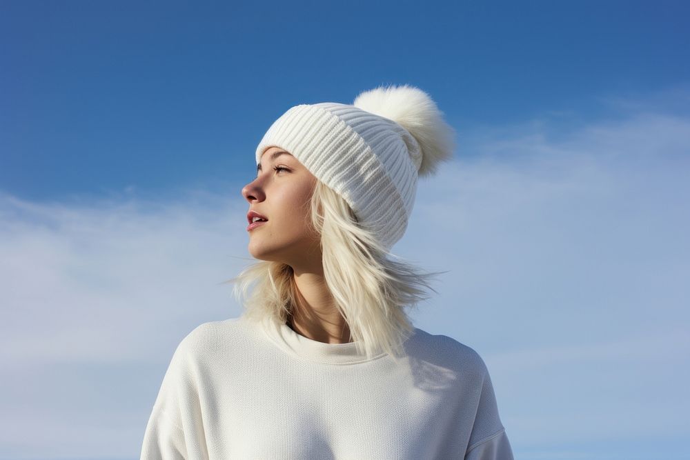 A woman blonde hair wearing white short matching flannel beanie adult blue sky.