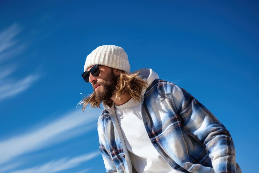 A adult man wearing white short matching flannel beanie blue sky photography.