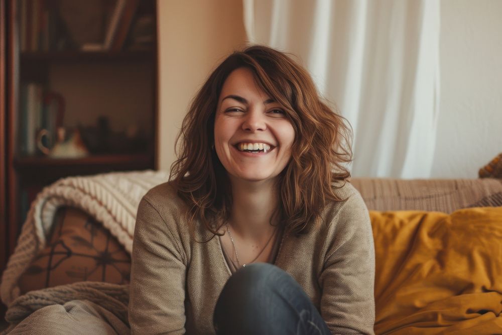 Woman laughing portrait sitting.