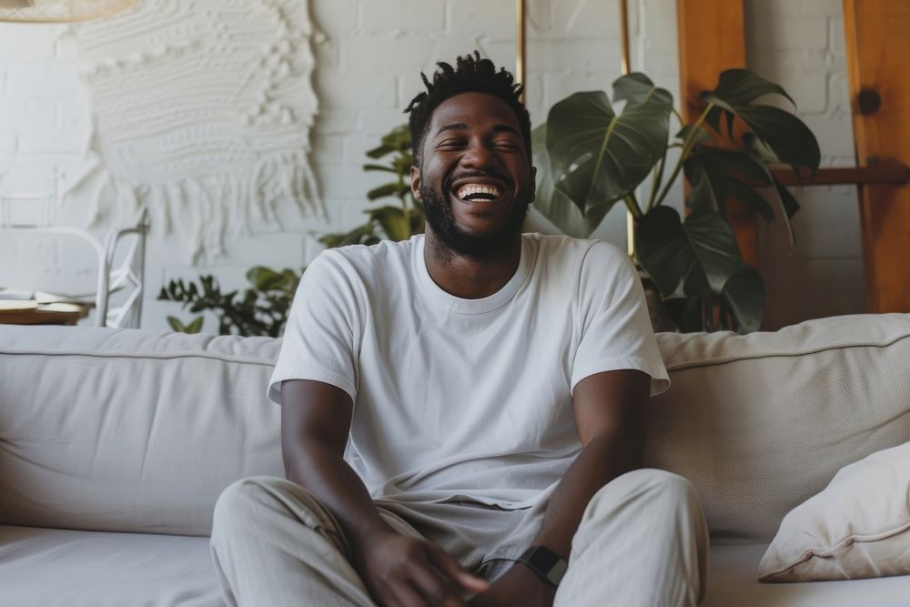 Black man sitting portrait laughing.