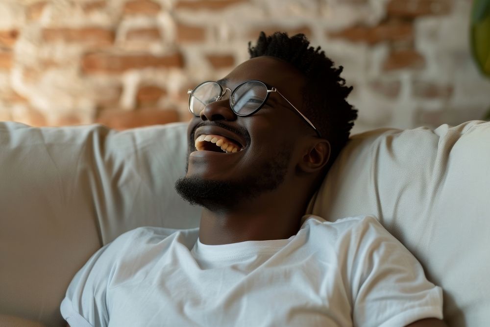 Black man portrait laughing glasses.