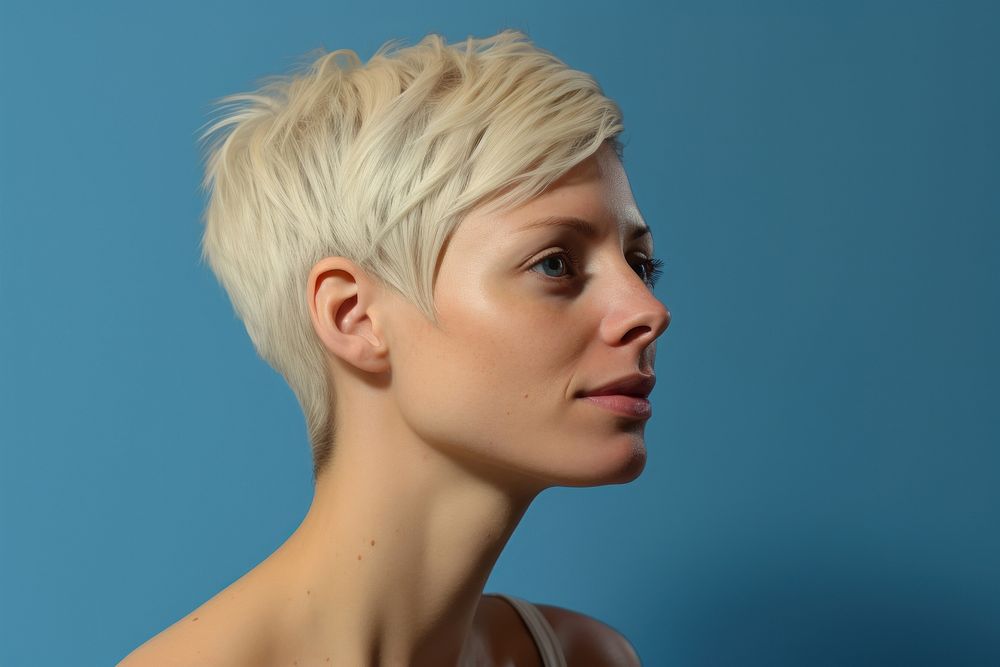 Woman short blonde hair portrait adult blue background.
