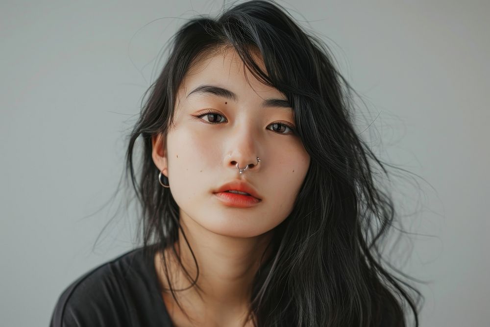 Asian girl piercing septum portrait adult skin.