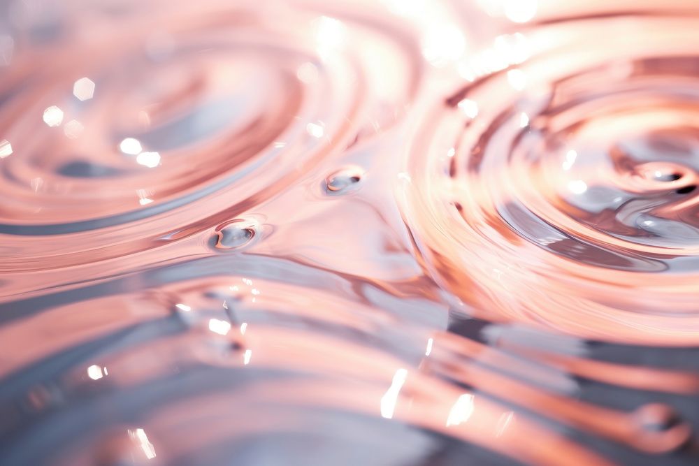 Circular water waves ripple pink wet.