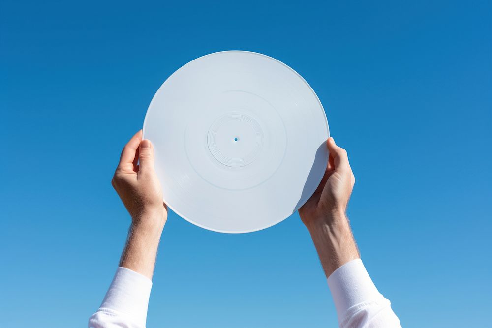 Hand holding white cover vinyls record hand blue sky.