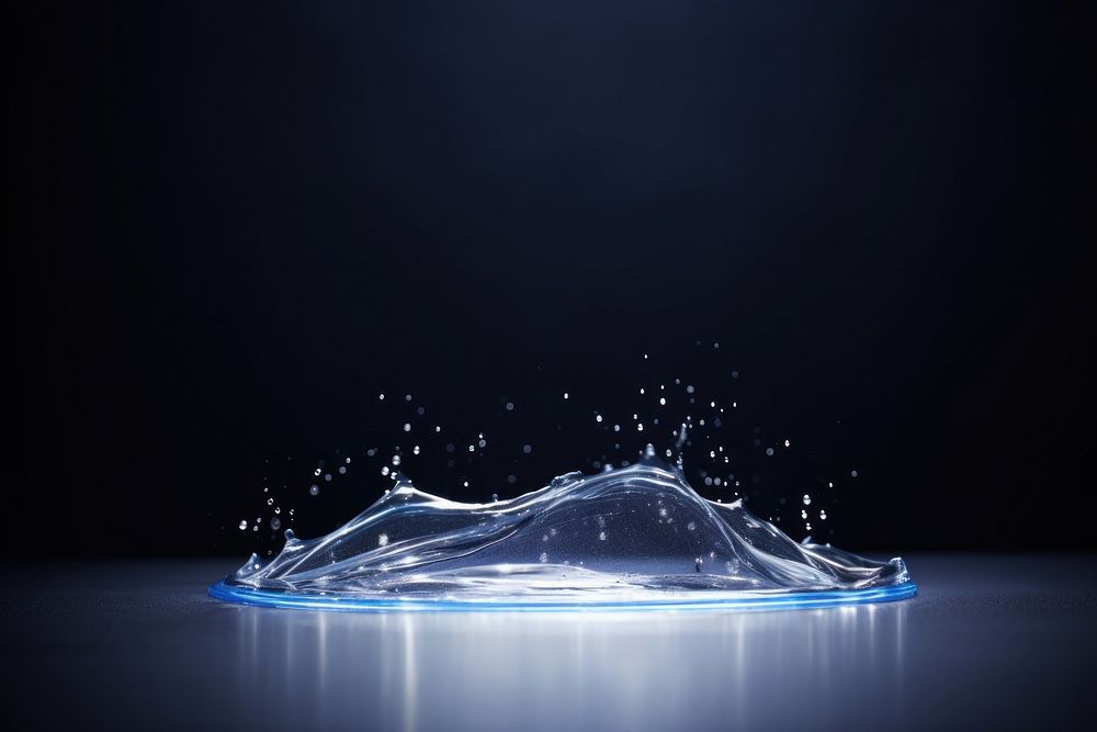 Liquid water forming of shape illuminated transparent reflection.