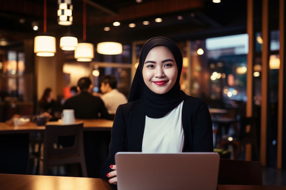Asian businesswoman in coffee shop laptop portrait computer. AI generated Image by rawpixel.