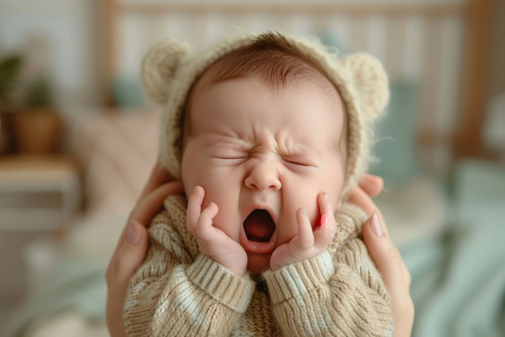 Baby girl making faces lying yawning newborn cute.
