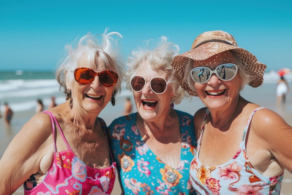 Old women friends fun sunglasses laughing.