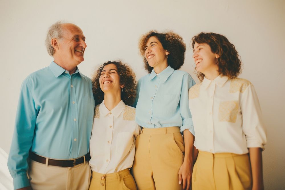 Black family wearing blank white shirt poses at studio for portrait pictures laughing parent adult.