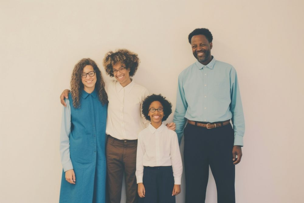 Black family wearing blank white shirt poses at studio for portrait pictures parent adult photo.