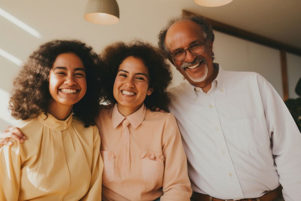 Black family wearing blank white shirt poses at studio for portrait pictures grandparent laughing adult.