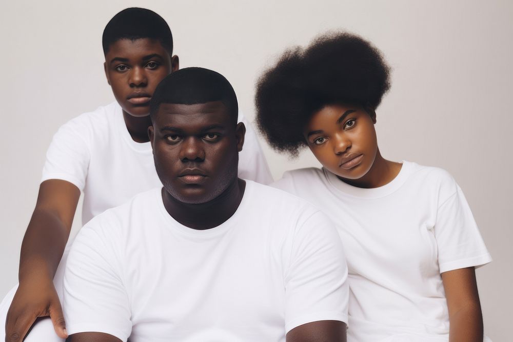 Black family wearing blank white shirt poses at studio for portrait pictures adult photo togetherness.