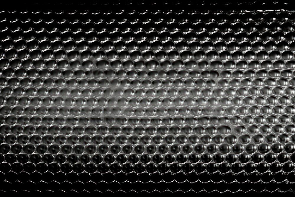  Bubble wrap backgrounds texture black. AI generated Image by rawpixel.