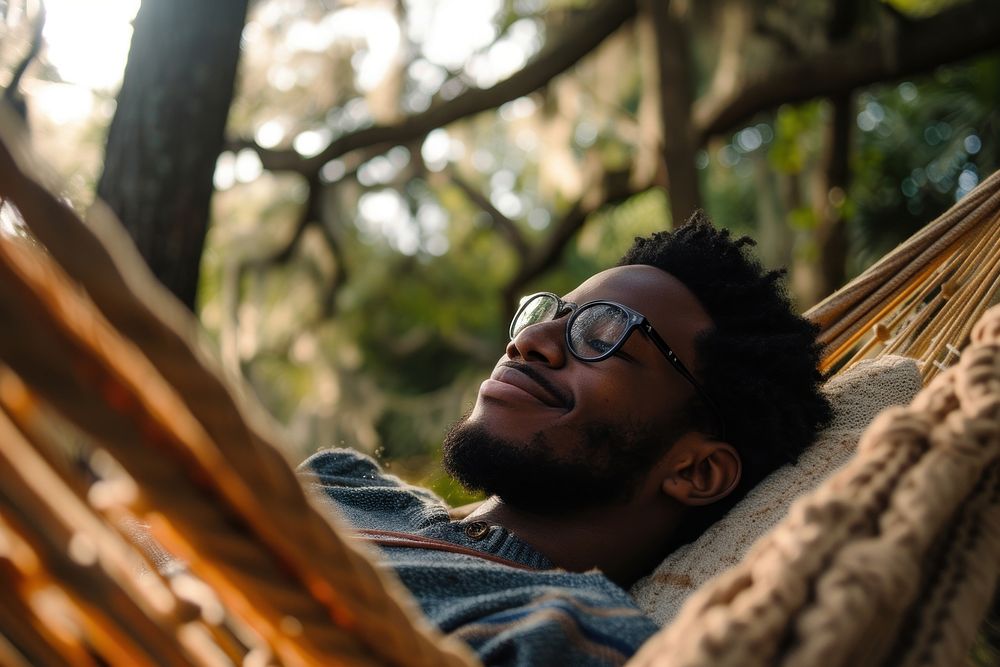 Black person relaxing content outdoors.